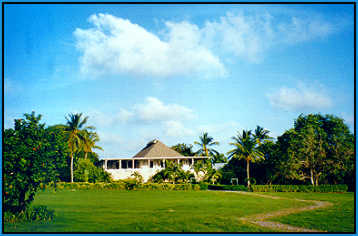 The main house, called the Cotton House Club with a lovely lilly pond to the right.