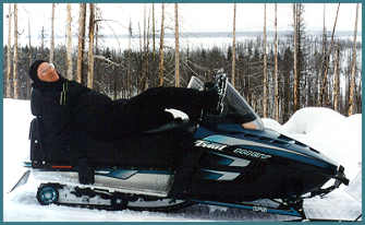 Hank Nuss relaxing on snowmobile after a day of taking photos!