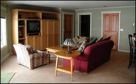 One bedroom suite living room with full kitchen and dining table