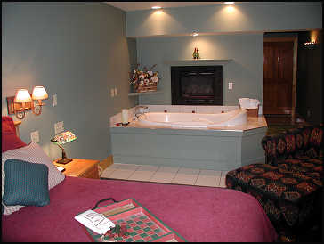King bedroom with fireplace above Jaccuzi tub