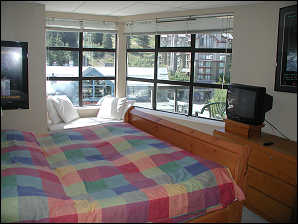 Master bedroom with queen bed and mountain view